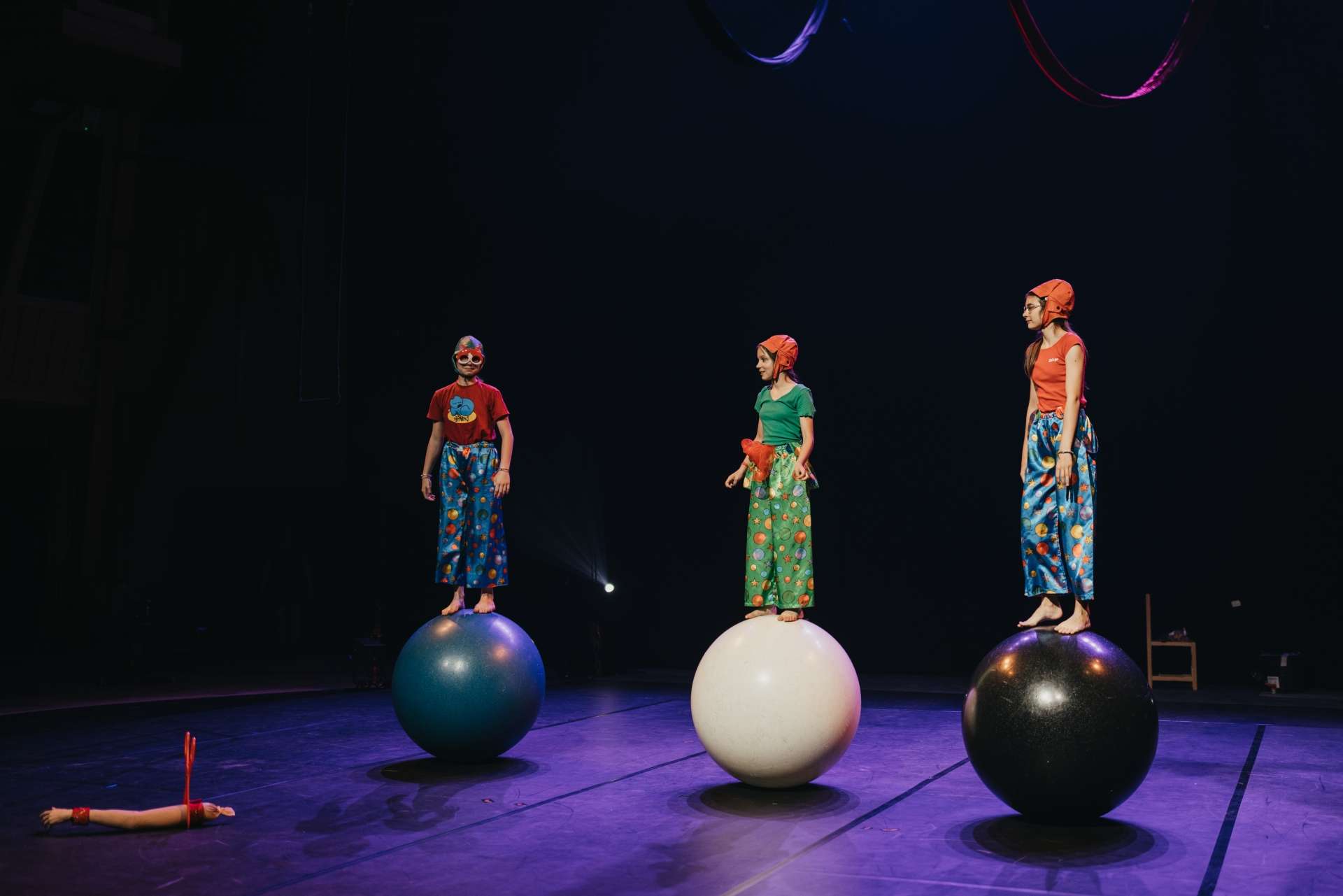 Trois élèves sur des boules d'équilibre dans un spectacle.jpg