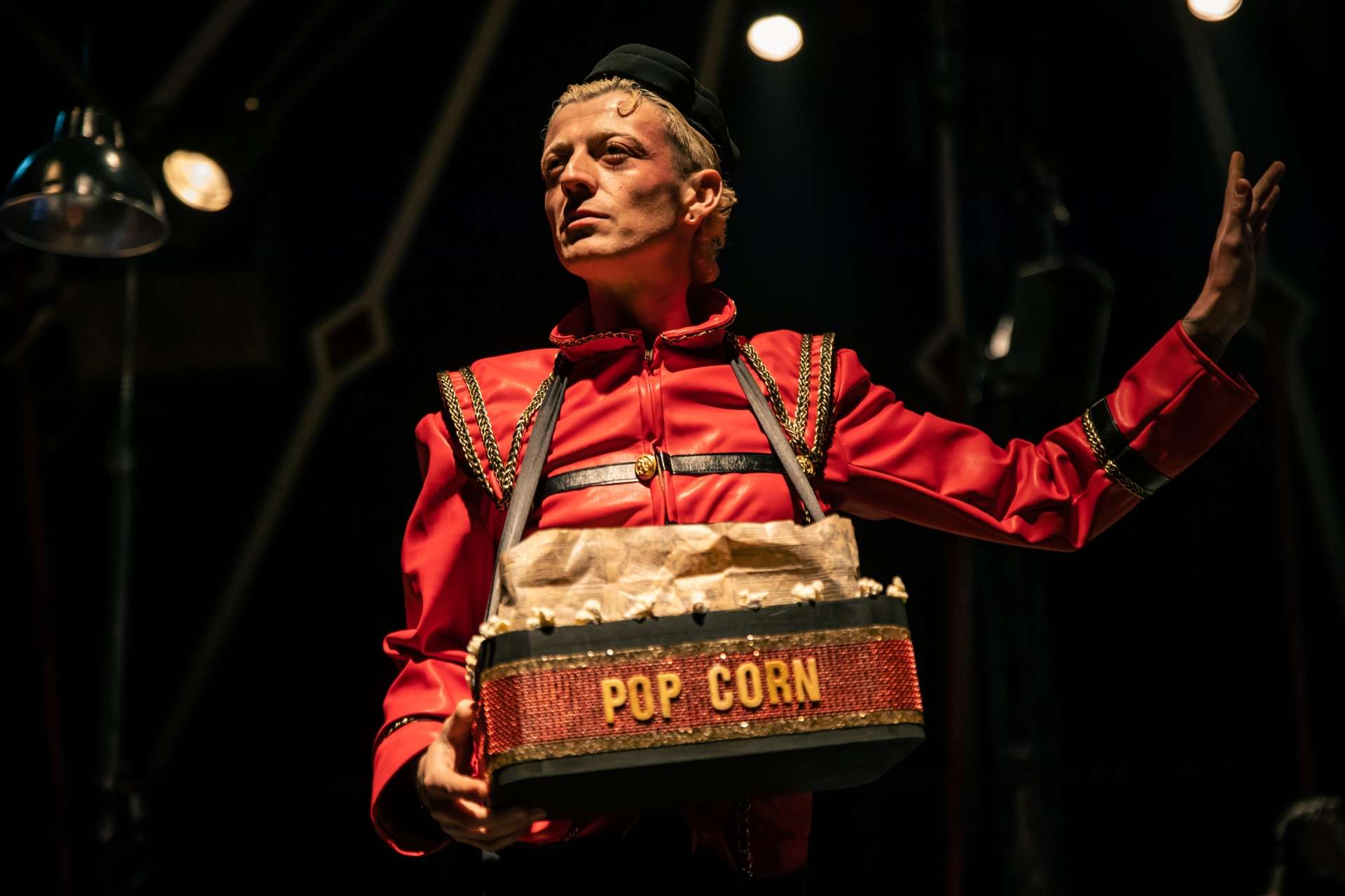 Un artiste costumé en Monsieur Loyal vend du popcorn